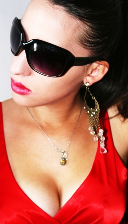 beautiful young girl with dark sunglassess with red dressの写真素材
