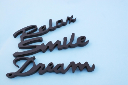 Close up of the words smile relax and, dream on a ble backgroundの写真素材