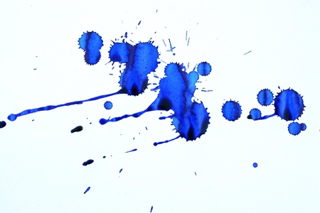 Blue ink stains on a white paper sheetの写真素材