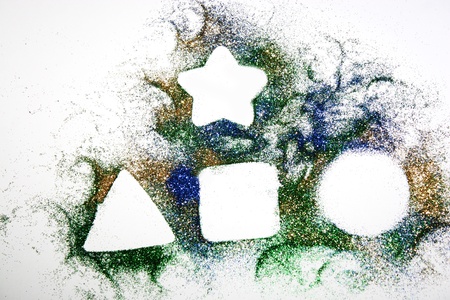 Various shapes on colored glitter powderの写真素材