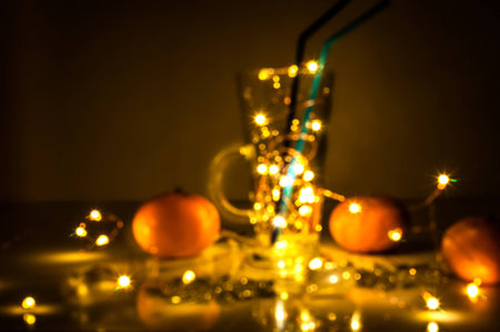 Blurred still life. A mulled wine glass with magic lightsの写真素材