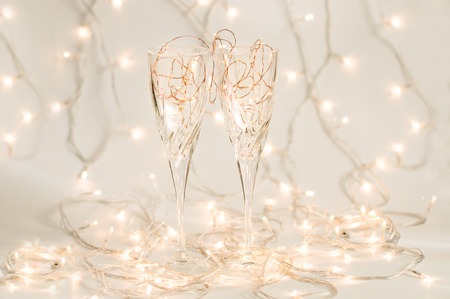 Two wine glasses with holiday lights insideの写真素材
