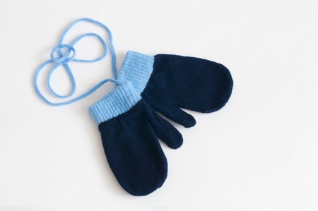Blue knitted mittens isolated on a white background. Winter symbol.の写真素材
