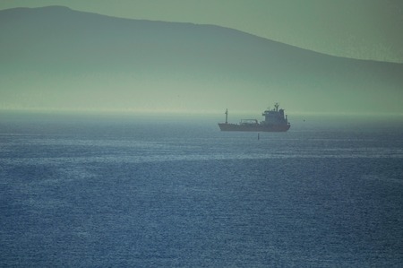 Cargo ships waiting to enter the Novorossiysk port in foggy weatherの写真素材
