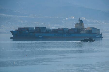Large full loaded container ship going through the bayのeditorial素材