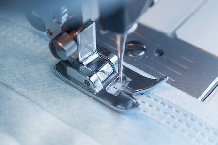 Sewing the medical mask on a sewing machine at home.の写真素材
