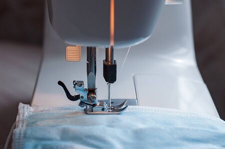 Sewing the medical mask on a sewing machine at home.の写真素材