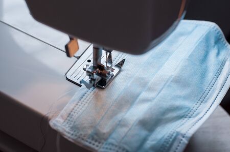 Sewing the medical mask on a sewing machine at home.の写真素材