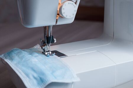 Sewing the medical mask on a sewing machine at home.の写真素材