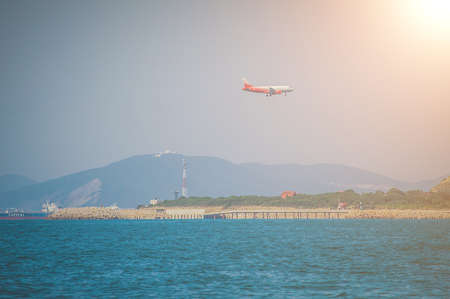 Landing of a passenger plane in airport of Gelendgik, Russia. View from the sea. Selective focus