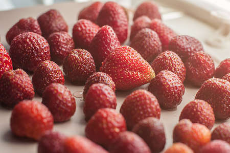 Peeled red strawberries. Summer background. Healthy food.の写真素材