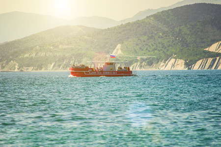 Red tourist ship crossing Black sea with tourists on board. Water trip.の写真素材