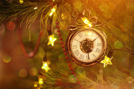 New year clock toy for christmas decoration haning on a Christmas tree. Holiday background.の写真素材