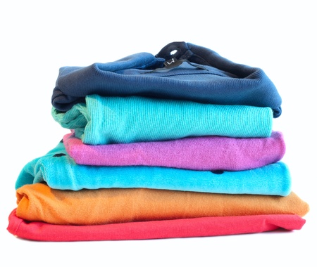 Pile of coloured clothes from the laundry - isolated on whiteの写真素材