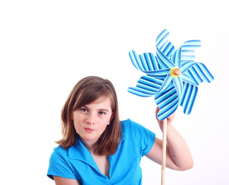 Cute girl with pinwheel isolated on white.の写真素材