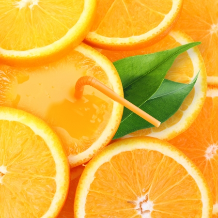 Stack of orange fruit slices with juce background.の写真素材