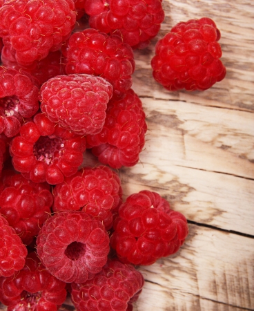 Red raspberry on wooden background