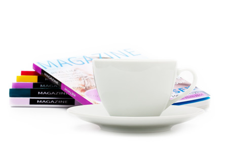 White coffee cup and magazines on white backgroundの写真素材