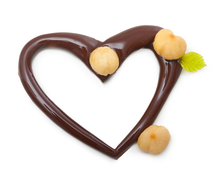 Chocolate heart with nuts on a white backgroundの写真素材