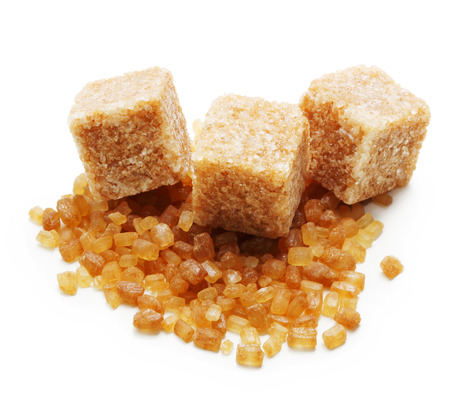 Brown cane sugar cubes n white background.の写真素材