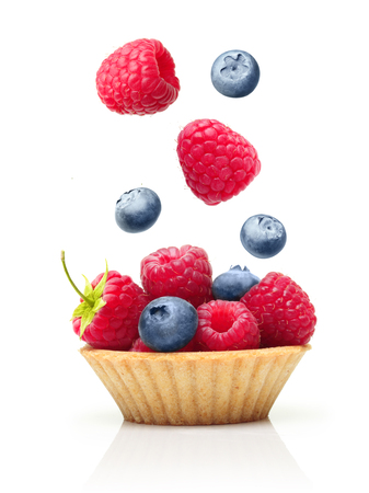 Sweet dessert, cupcake with raspberry and blueberry isolated on white background.の写真素材