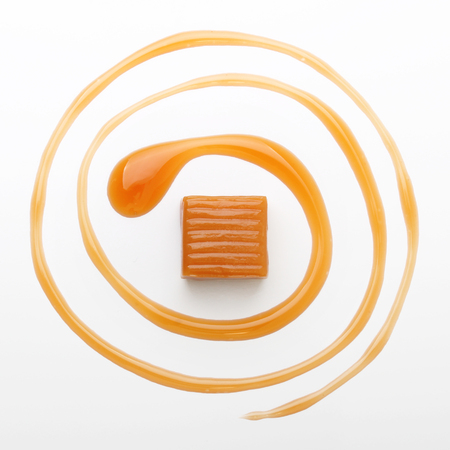 Caramel toffee and sauce isolated on a white backgroundの写真素材