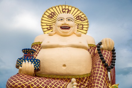 Giant Budai or Pu-Tai or Happy Buddha or Laughing Big Buddha statue at Wat Plai Laem Temple in the Samui island in Thailandの写真素材