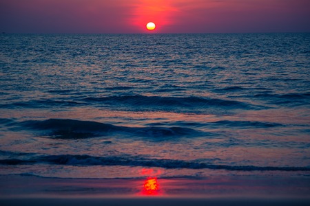 Beautiful pink sunset sun on the seaの写真素材