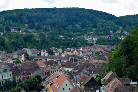 Summer panoramic landscape of the old town. Old houses with orange brick roofs. Sighisoara, Mures County, Transylvania, Romania.のeditorial素材
