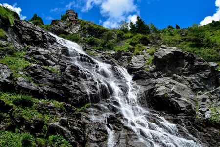 Capra Waterfall next to Transfagarasan  alpine mountain road in southern section of Carpathian Mountains in Romaniaの写真素材
