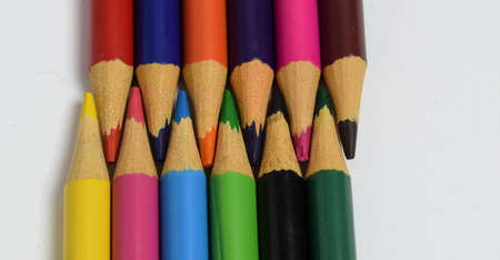 colored pencils arranged head to head isolated on a white background. wooden pencils backgroundの写真素材