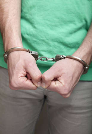 Young man in handcuffs