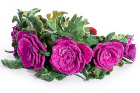 Wrap hair with a decorative ornament in the form of flowers from fulled wool on a white backgroundの写真素材