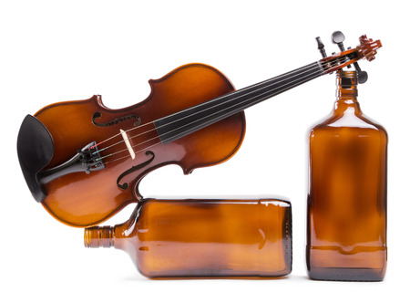 Figurative composition of the bottles with a violin on a white backgroundの写真素材
