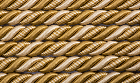 Background of intertwined threads of goldの写真素材