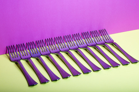 Abstract still-life with forks on a colorful backgroundの写真素材