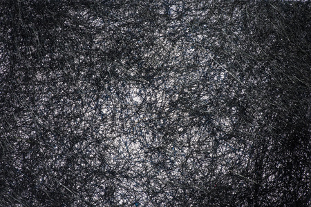 Abstract image of a plurality of intertwined black strandsの写真素材