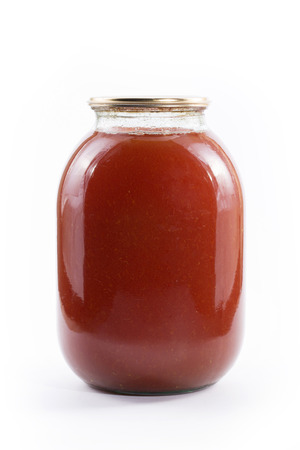 Three-liter jar of tomato juice on a white backgroundの写真素材