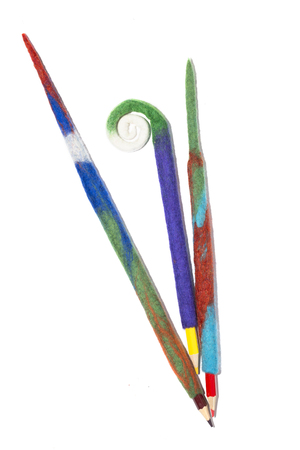 Pencils in a case of felted wool on a white backgroundの写真素材