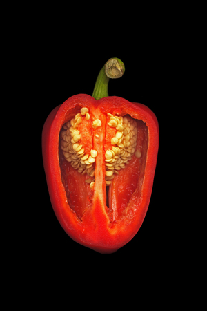 Sweet red capsicum in a section on a black backgroundの写真素材