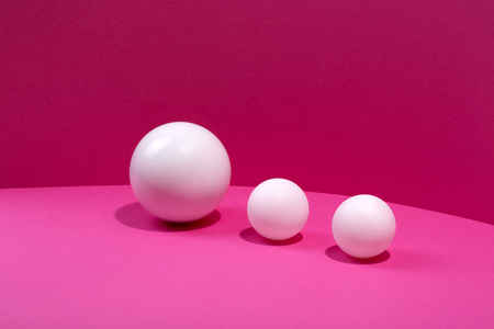 Abstract still life with white balls on a pink backgroundの写真素材
