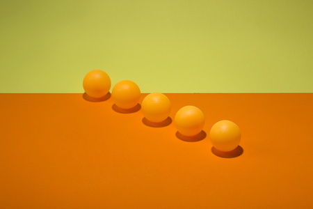 Abstract still life with orange balls on a colorful backgroundの写真素材