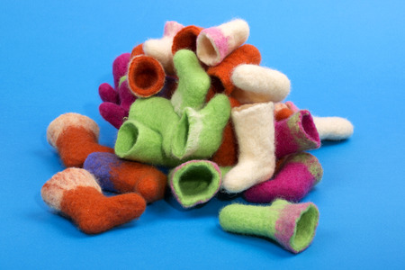 Heap of souvenir boots made of felted wool on a blue backgroundの写真素材