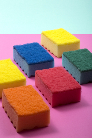 Multi-colored kitchen sponges on a colored backgroundの写真素材