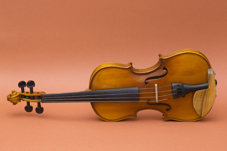 Musical instrument violin on a brown backgroundの写真素材