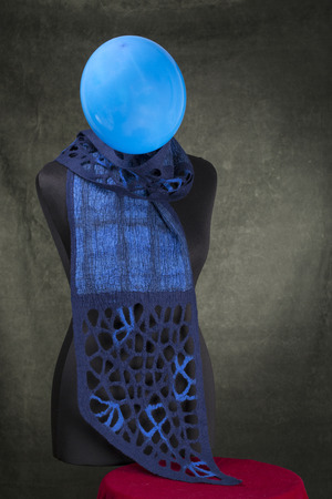 Blue female woolen scarf on a mannequin with a balloonの写真素材