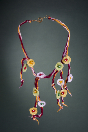 Womens woolen decoration on a green backgroundの写真素材