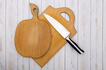 Two wooden kitchen chopping boards with a knifeの写真素材