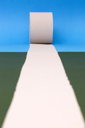 Roll of toilet paper on a colored backgroundの写真素材