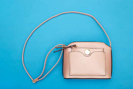 Pink Women's handbag on a blue backgroundの写真素材